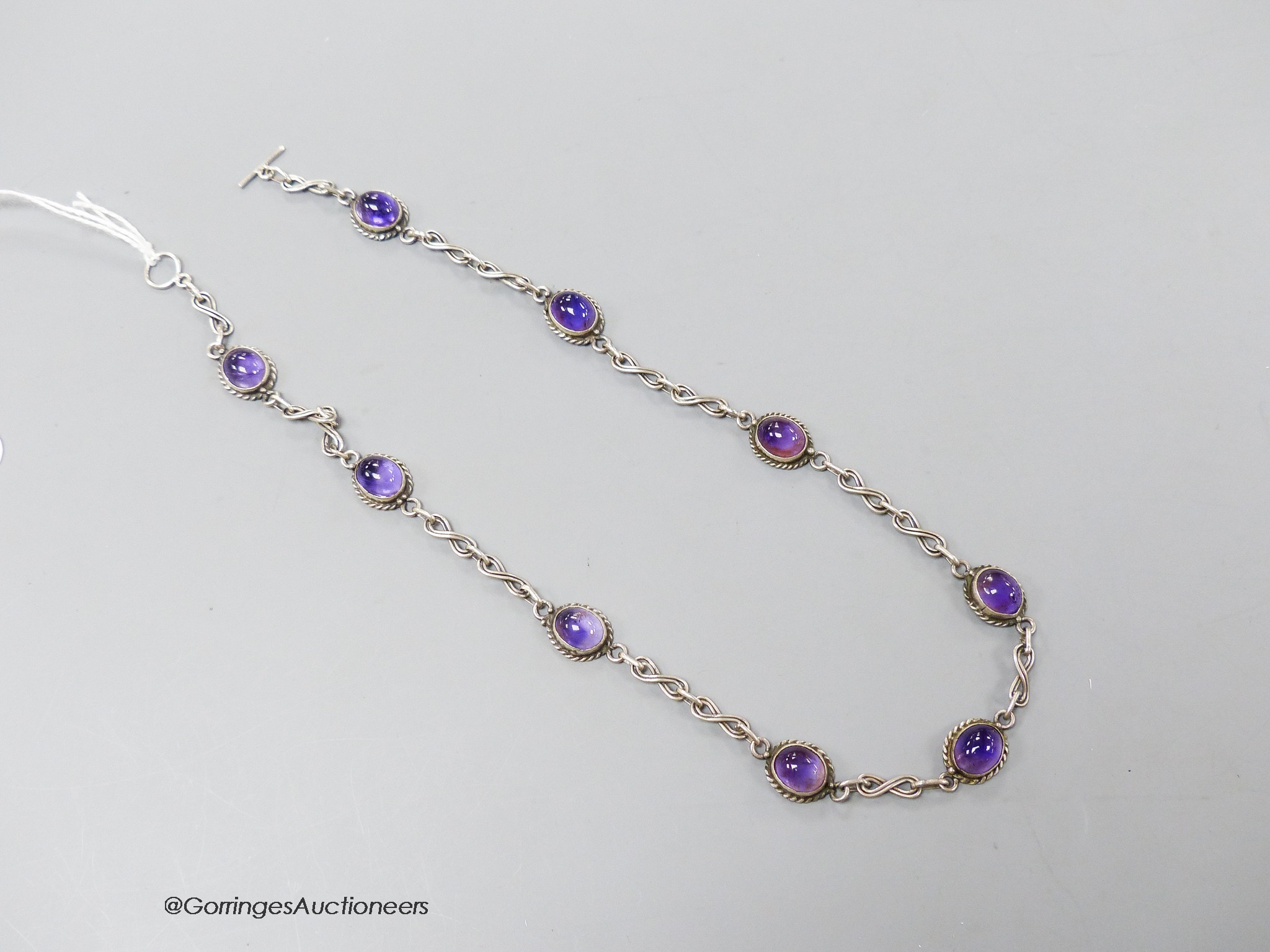 A 20th century white metal and cabochon amethyst set necklace, 41cm.